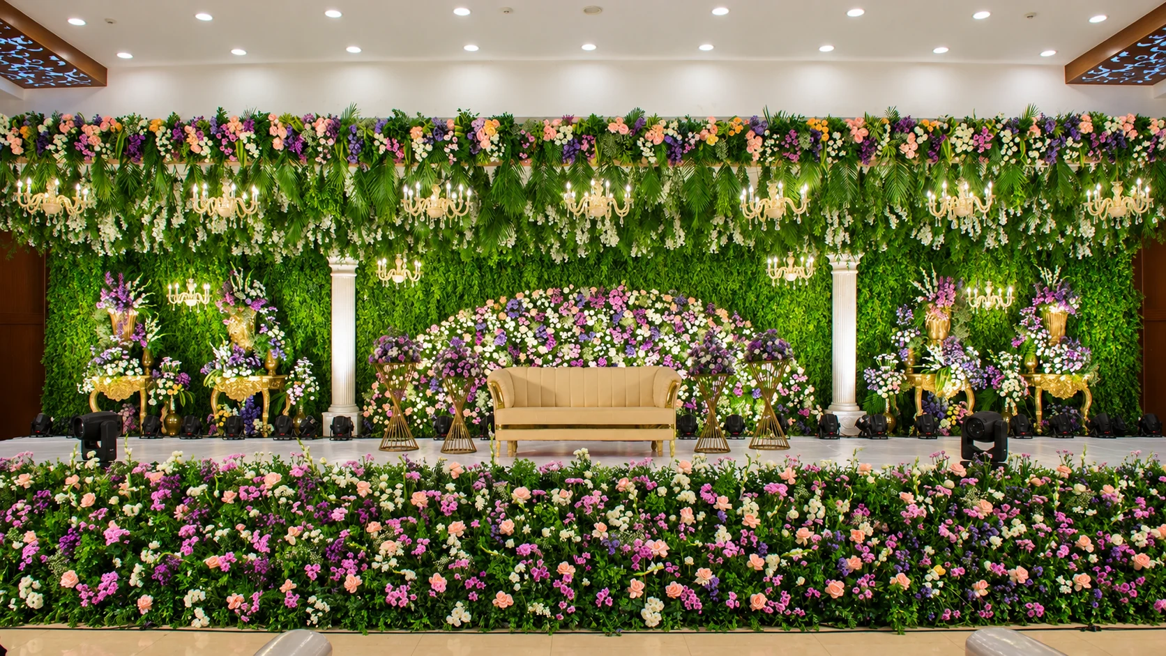 Lush floral reception stage with elegant seating
