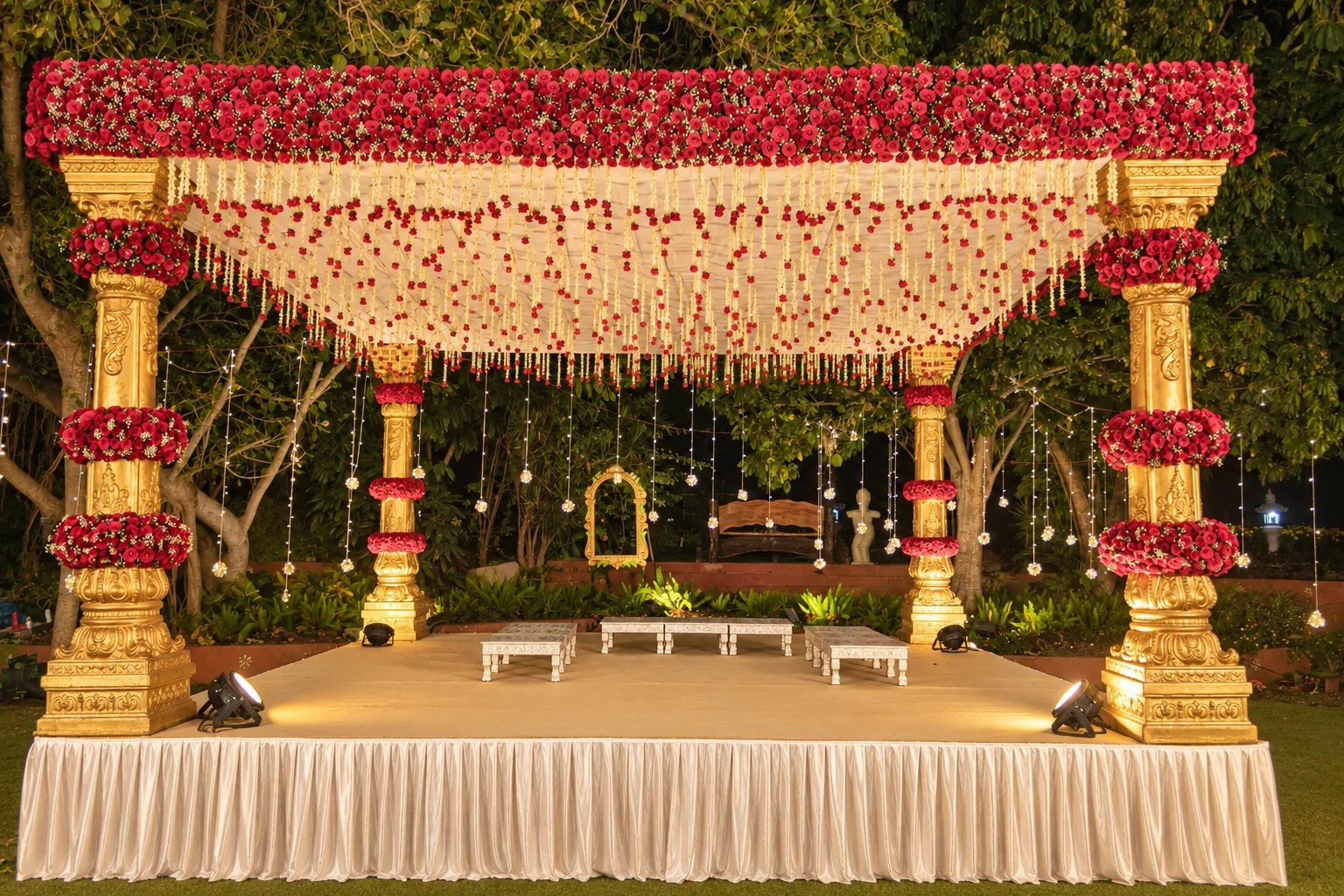 Traditional red and ivory floral mandap at night