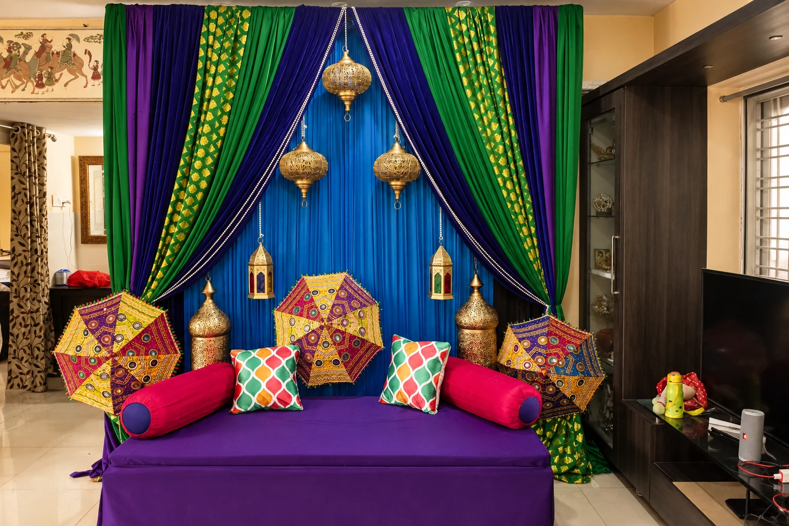 Colourful mehndi lounge with jewel toned drapes and cushions
