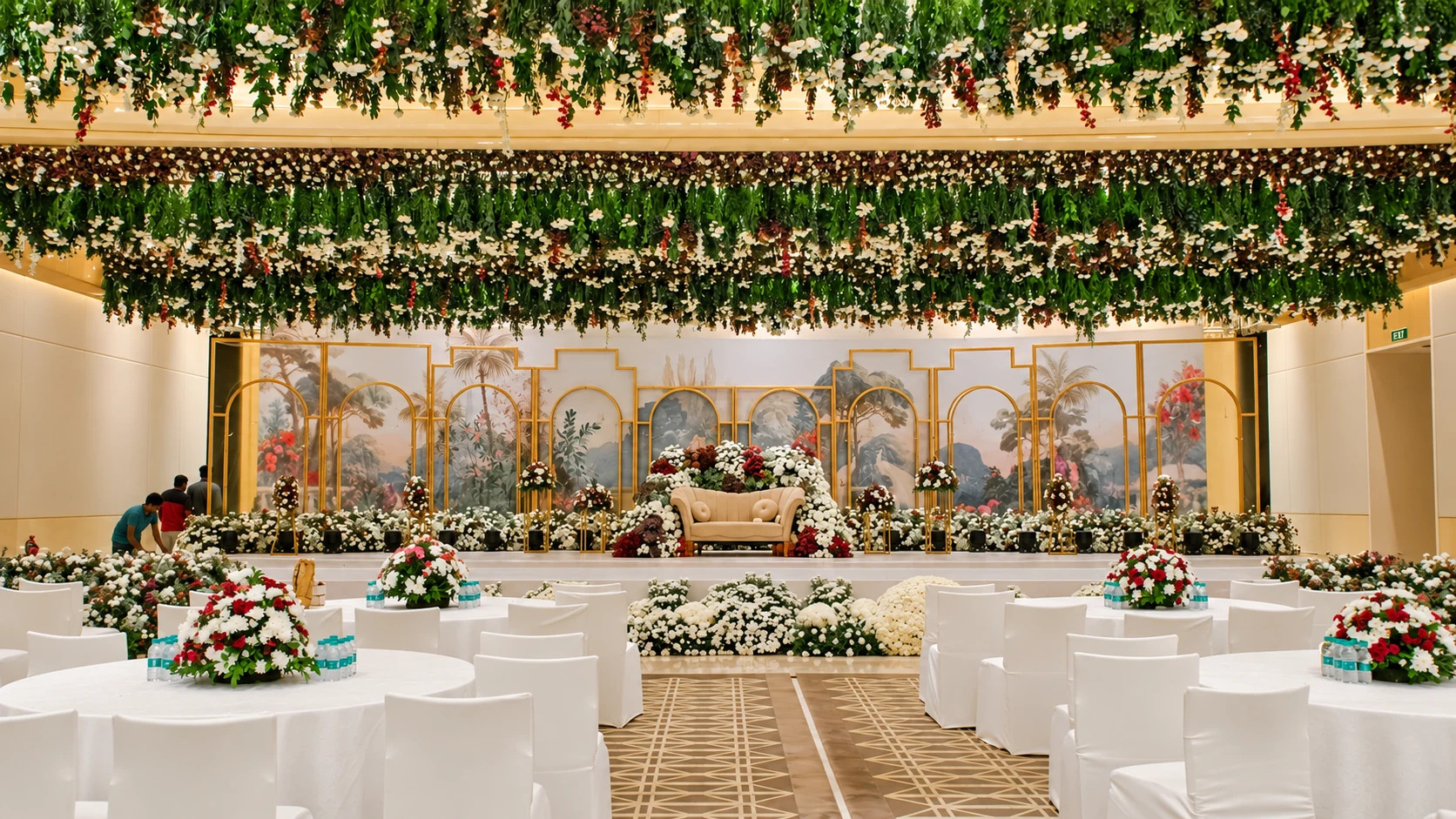 Wedding dining tables beneath a canopy of flowers