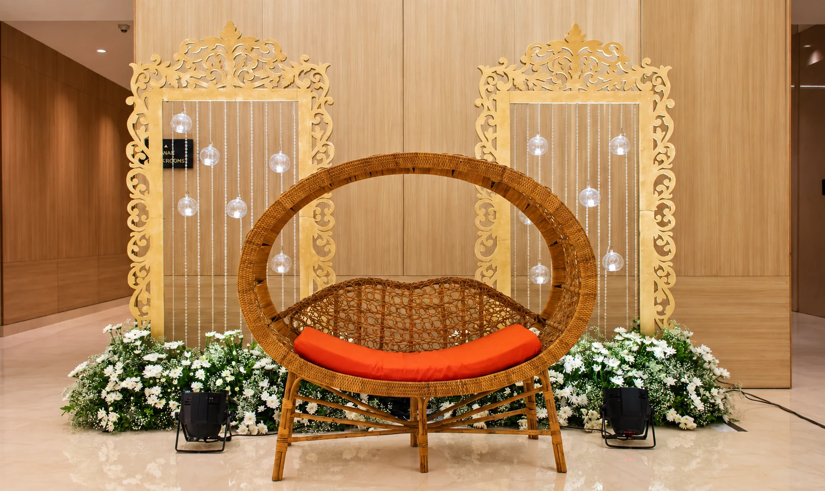 Statement cane chair framed by ivory flowers