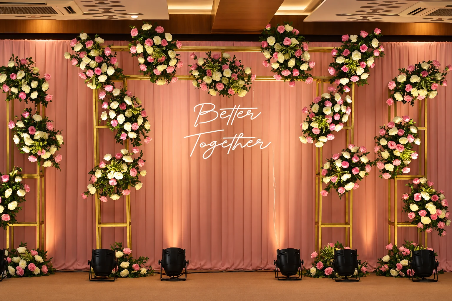 Pink draped backdrop with rose arrangements and Better Together neon sign